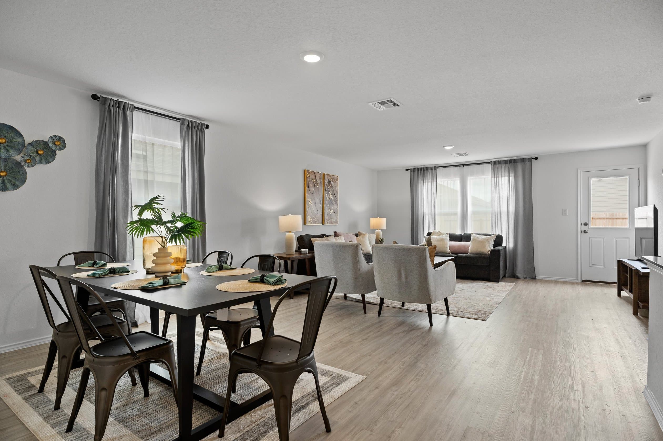 Open-concept furnished living and dining area